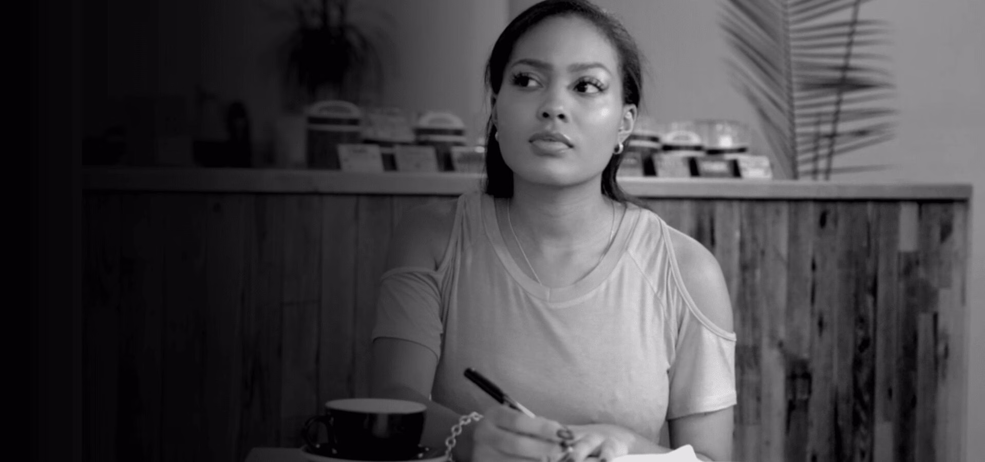 Girl sitting at a table writing 